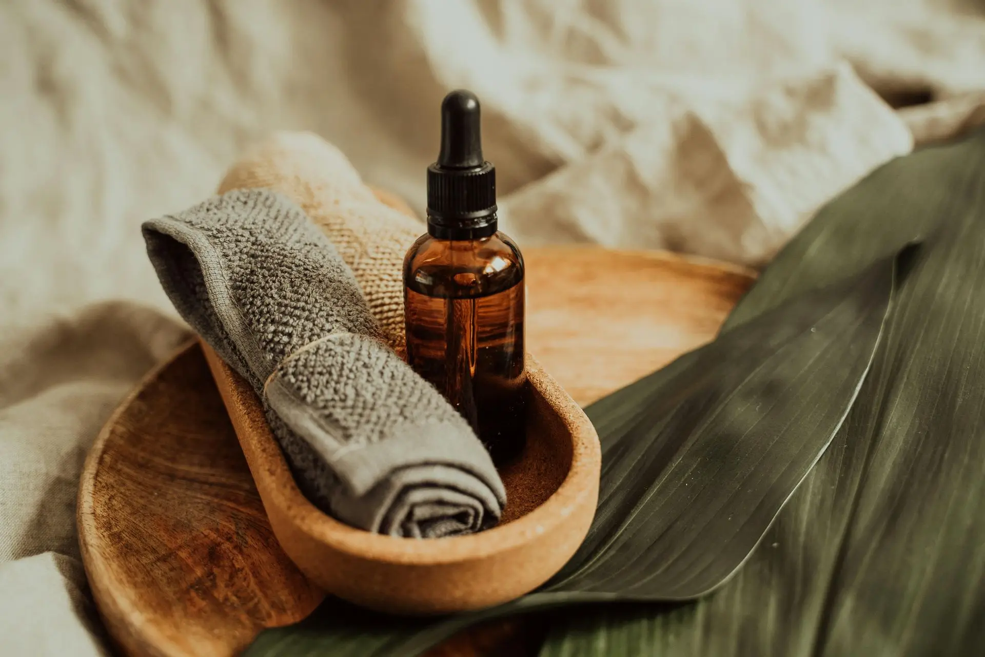 Gentle rituals for daily peace and elderly wellness Essential oil and towel setup on wooden tray.